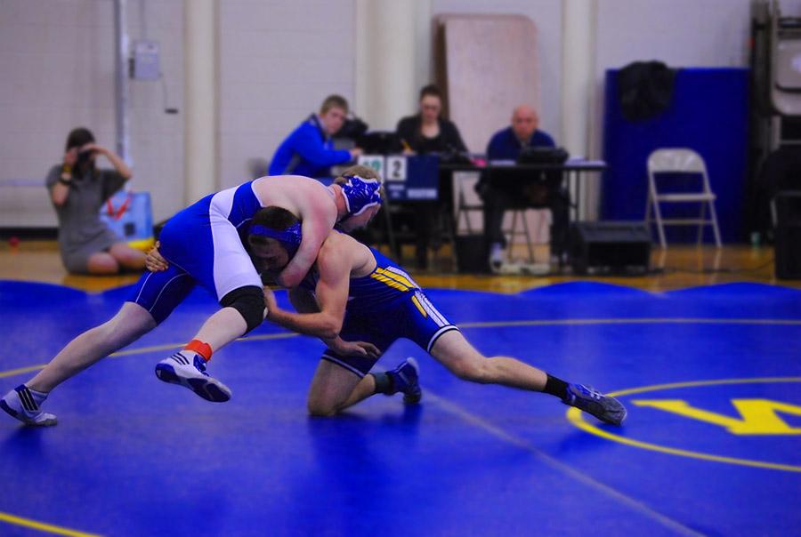 Senior Chris Miller attempts to take down his opponent from Spotswood during the district meet.