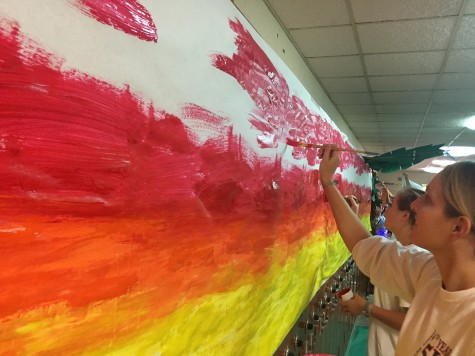 Ms. Hyman helping paint the Junior Lilo & Stitch Hallway