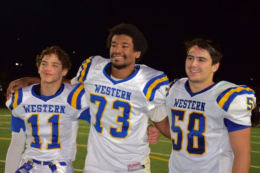 Crutchfield (center, 73) smiles for pictures after win over CHS.