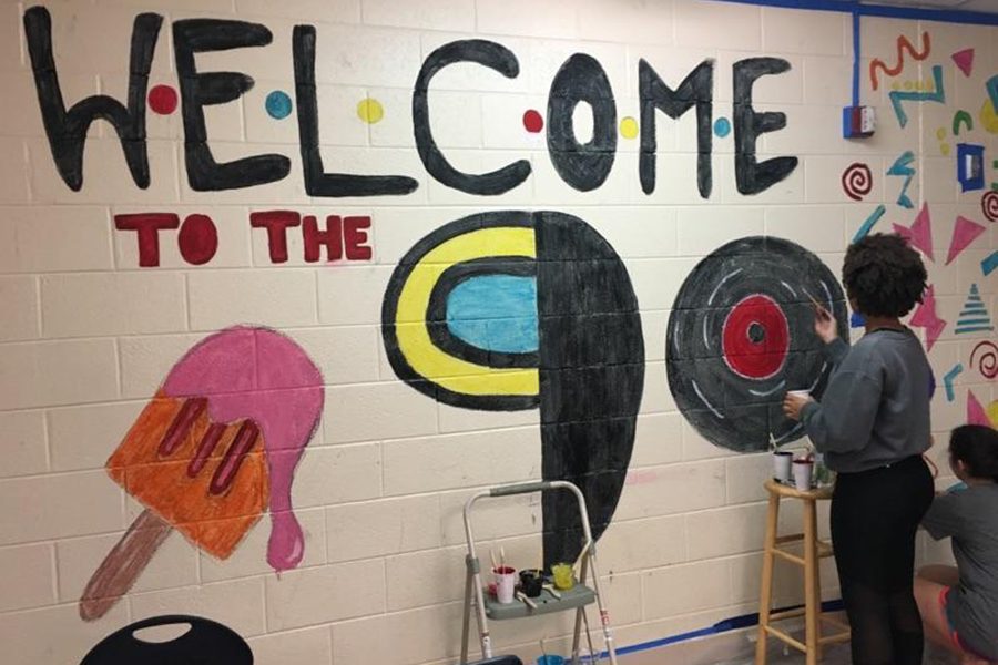 Jeida Brooks and Sammy Betker painting the sophomore hallway.