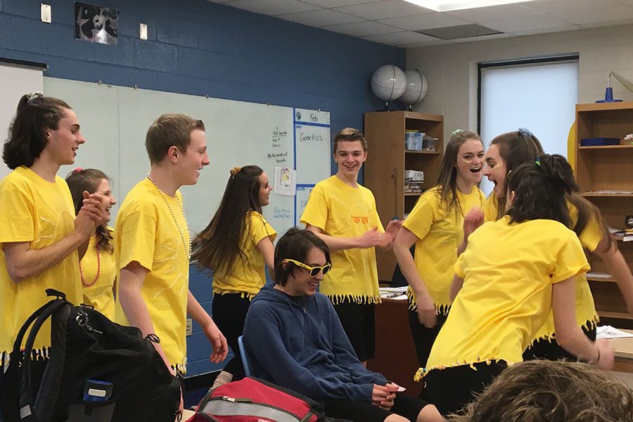 Reid Stradling, Maddie Zobrist, Cate Zobrist, Aimee Schill, Rylee Franklin, Emily Flanders, Caleb Harris, and Isaiah Sorenson sing Walking on Sunshine to a student.