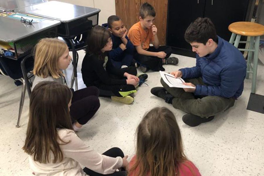 Freshman Ryan Knutsen reads his story to third graders at Brownsville Elementary. 