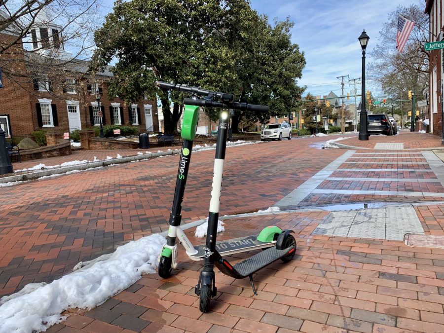 Rival e-scooters Lime (left) and Bird (right) parked in Charlottesvilles Court Square.