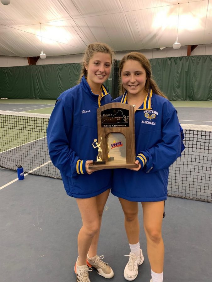 Austin Winslow, at right, and teammate Stephanie Hass hold the state championship trophy after winning the tournament last year.