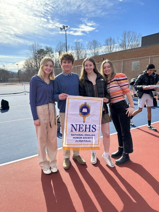 NEHS officers pose with a club banner at the induction ceremony of new students into the club in the fall of 2022.