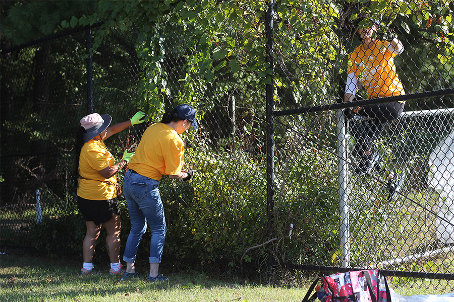 Volunteers+from+Sentara+work+to+clean+up+the+WAHS+football+field+on+September+20th.