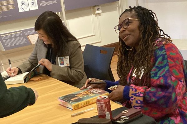 (R to L) Jimin Han and Denene Millner sign books and engage with event attendees.