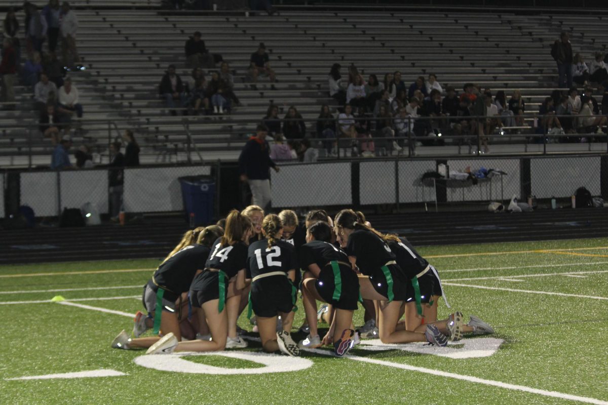 The junior team forms a huddle after a win in their first game against the freshmen.