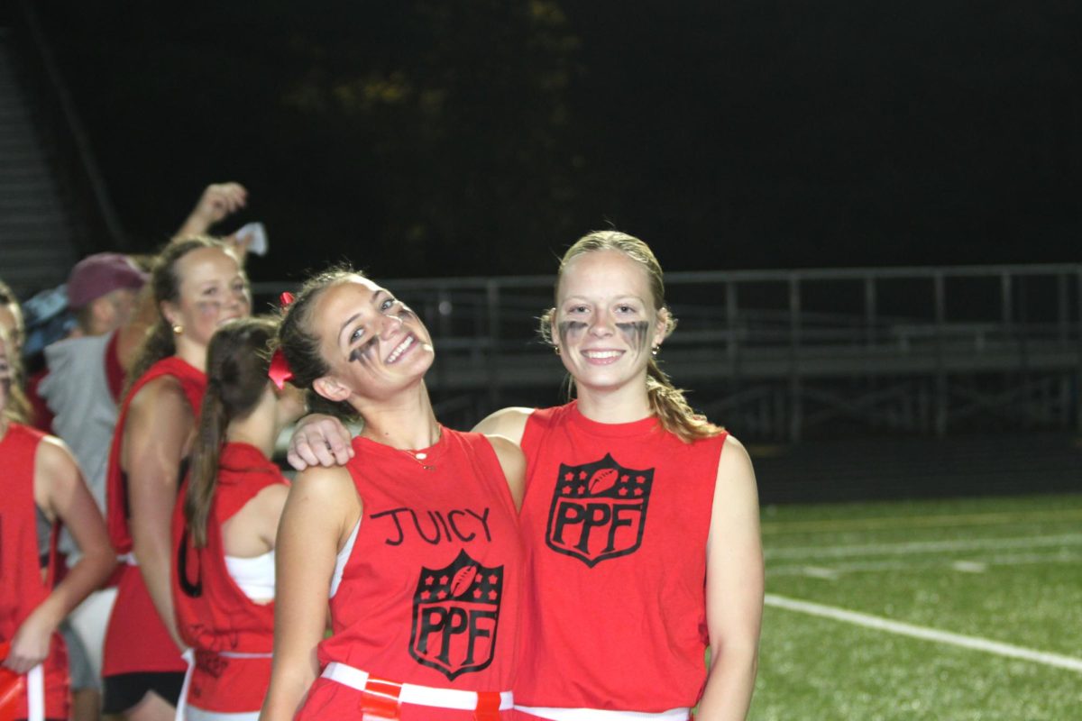 Seniors Ava Nauman and McClean Stokes celebrate on the sidelines. 