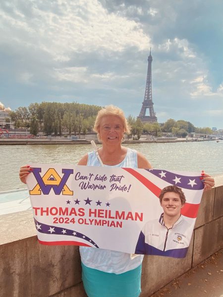 With a view of the Seine, Bette Garbett (aka Mrs. G) shows her support for Team USA swimmer and WAHS student Thomas Heilman.