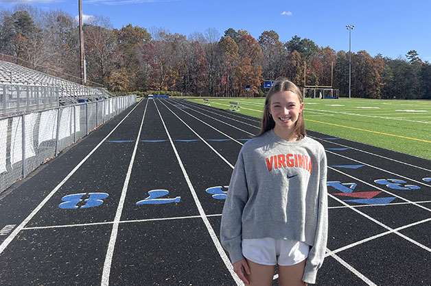 Sadie Adams poses infront of new and improved WAHS track and turf field that was redone over the summer.